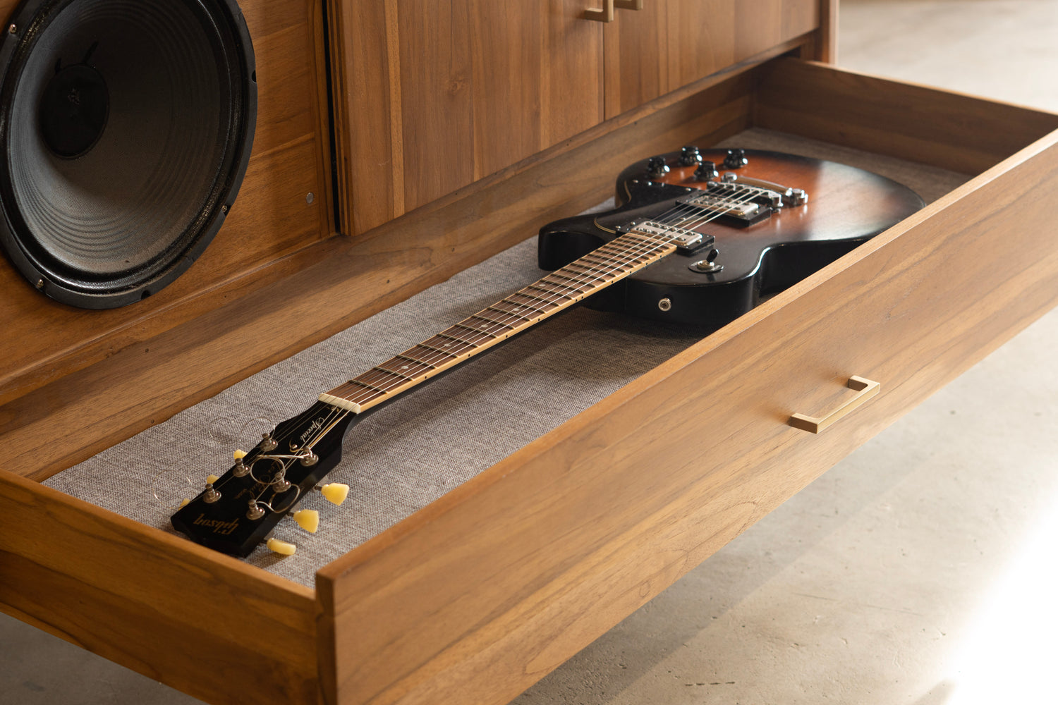 Guitar cabinet with guitar inside storage drawer